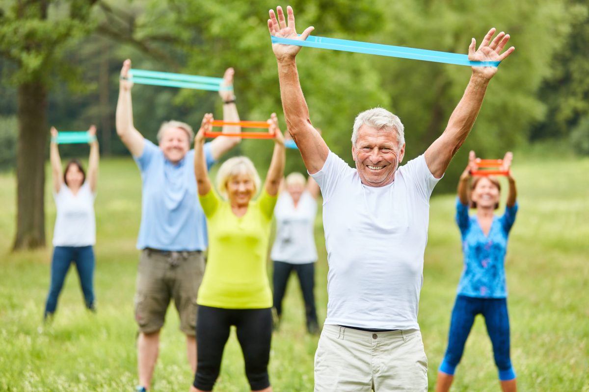 Seniors,Exercise,Fitness,With,Stretch,Band,In,Physiotherapy,In,Rehab